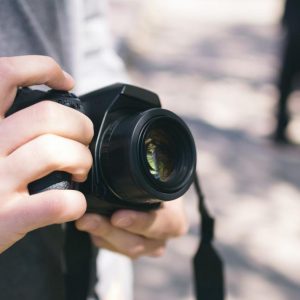 white man holding camera